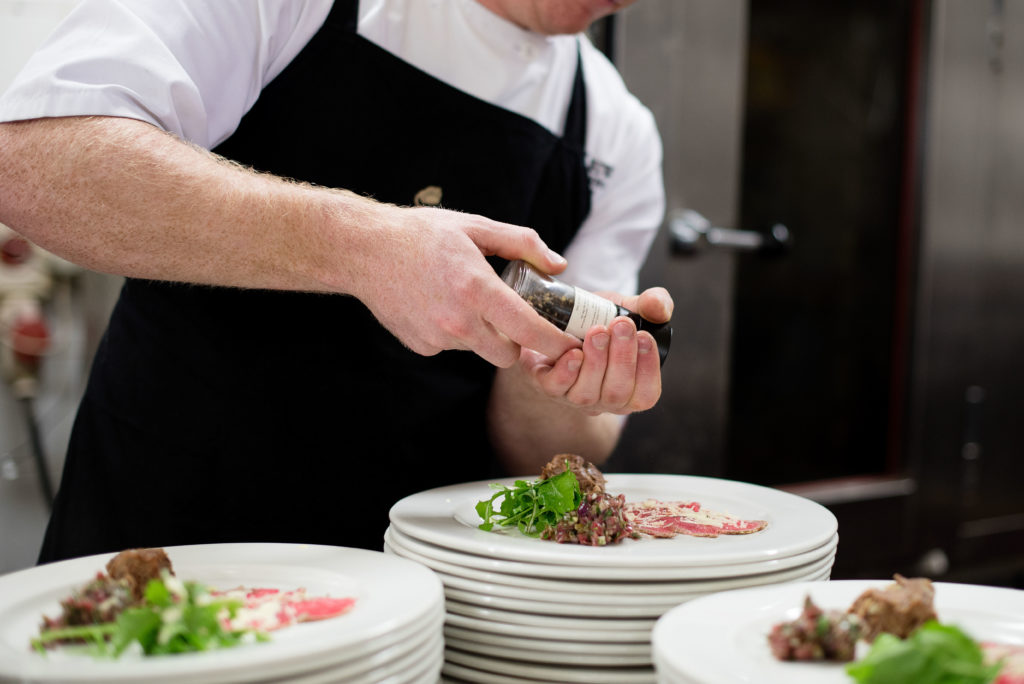 Chef plating fine dining meal